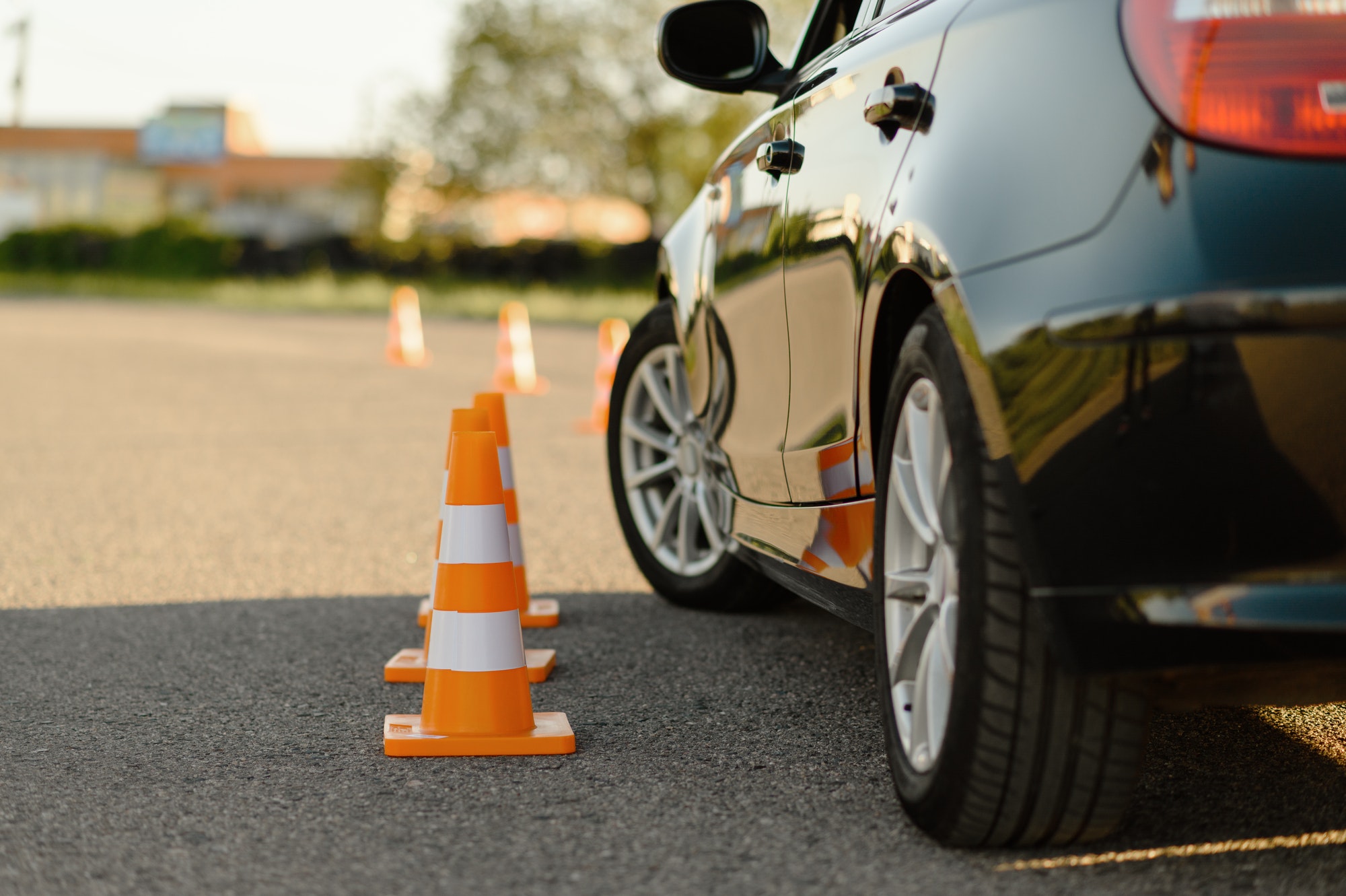 Car and traffic cones, driving school concept